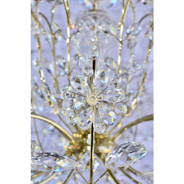 A grand crystal chandelier in Polished brass frame. Truly elegant furnishings influenced by 17th century French pieces....