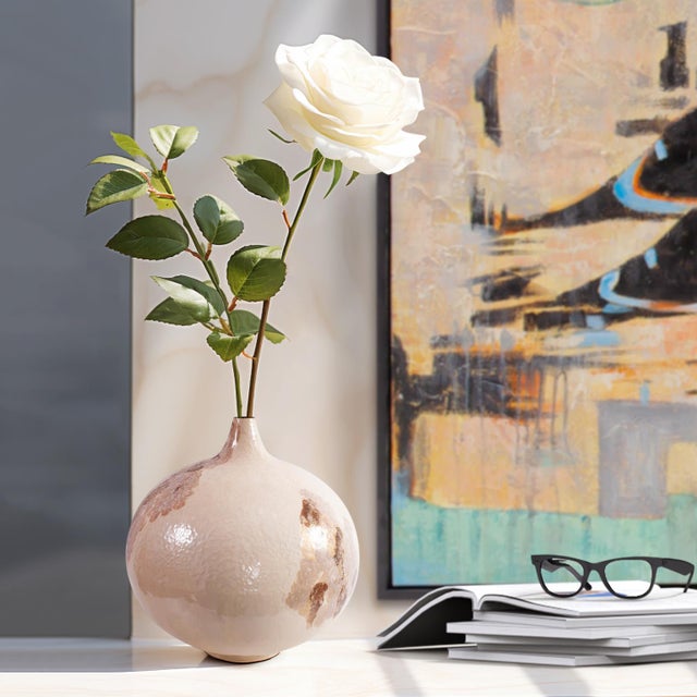 This striking short round vase is meticulously crafted from iron. Its rich sand-colored glaze creates a warm and inviting...
