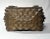 Varied tones of gold, silver and aged wood adorn this antique lidded tramp art decorative box catching the light that...
