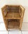 Boho chic two tiered rattan and wicker shelf. Great for plants or books. Nice detail on the sides. Interior of shelf...