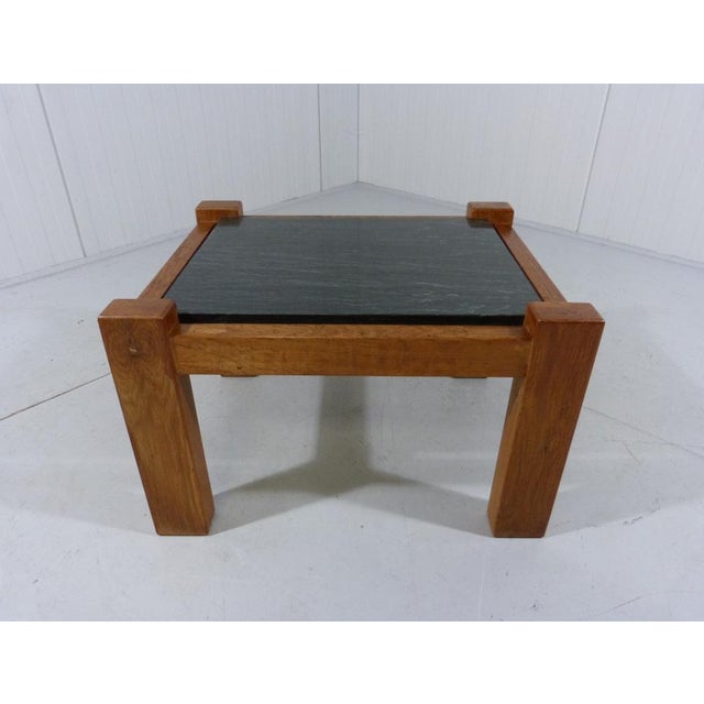 Nice sturdy brutalist coffee or side table. Solid oak wooden frame, black natural stone tabletop. The corners of the...
