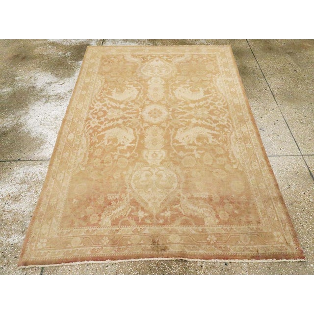 An antique Indian Agra accent rug. Indian rugs often have peculiar iconographies. Here roosters are paired in the heart-...
