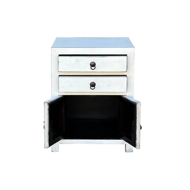 This is an oriental-style end table nightstand with 2 drawers painted with a rustic off white surface color. A simple...