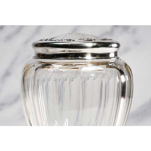 A beautiful example of early 20th-century elegance, this circa 1910s crystal and sterling silver lidded vanity jar...