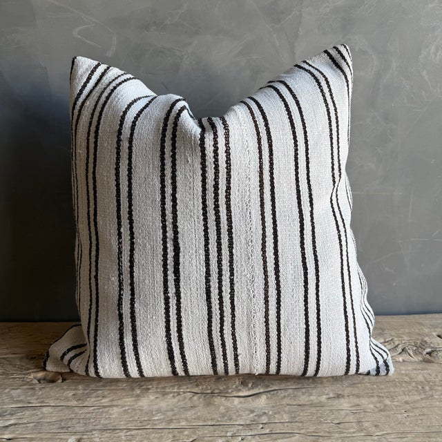 Creamy white hemp rug pillow with stripes. Soft hand, linen blend backing with zipper closure. Spot cleaning is...