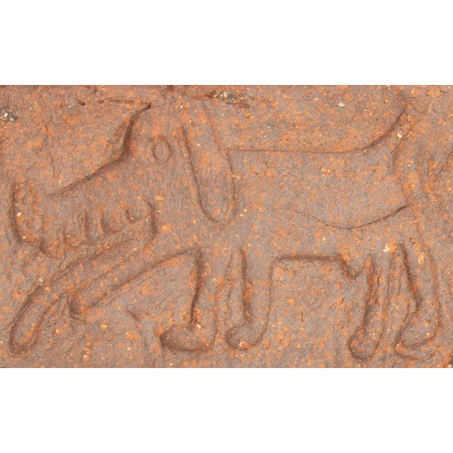 A studio pottery tile by the American artist Mark Bulwinkle (born 1946). This round tile features the impressed image of a...