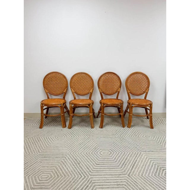 This lovely set of four vintage cane and rattan round dining chairs with cushions are a warm and beautifully crafted...