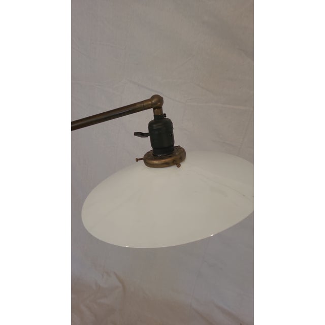 This Industrial floor lamp has a unique cast iron base and milk glass shade. 3 points of adjustment make it very...