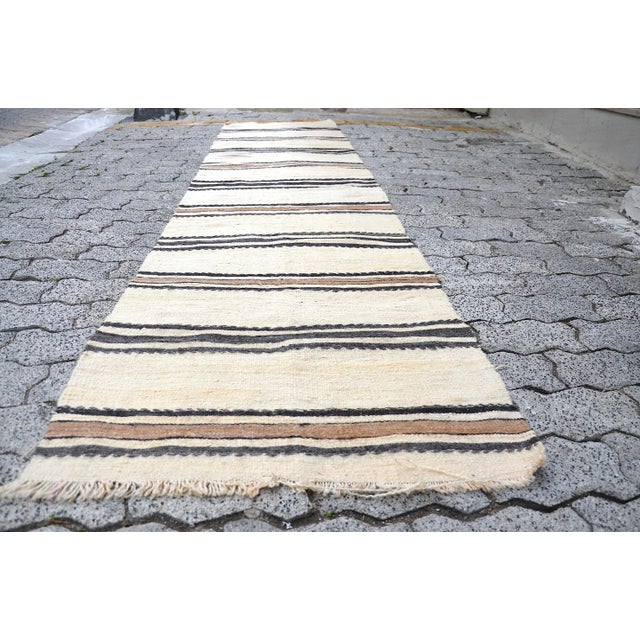 This is a vintage Turkish Anatolian kilim rug from the 1960s. The piece was hand-woven.
