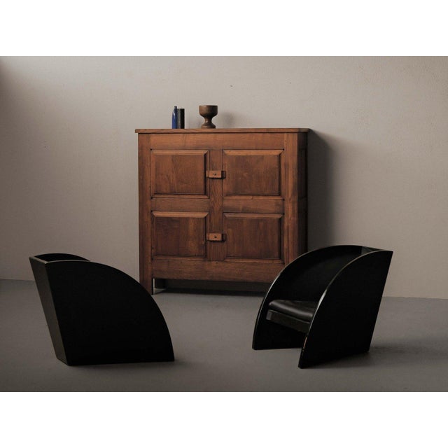 Four-door sideboard, crafted from solid oak in France around 1960, features an architectural façade composed of four...