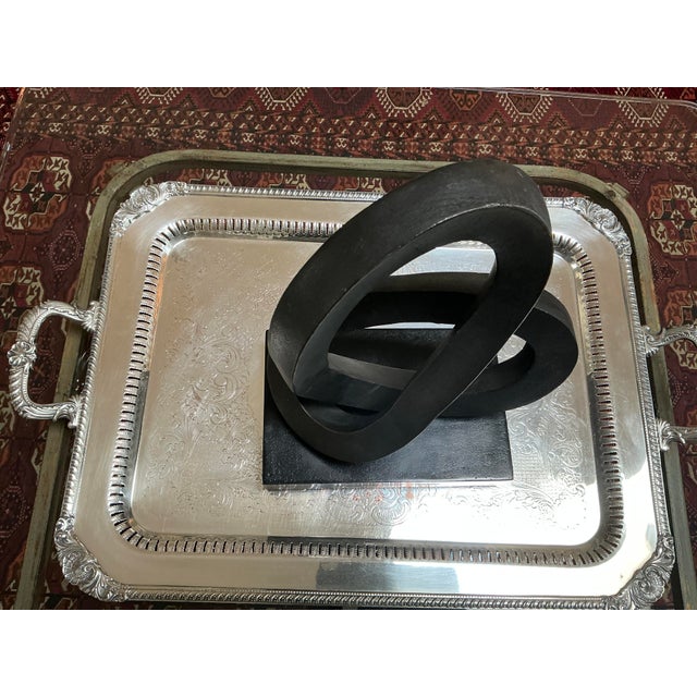 A show stopping piece of contemporary art displaying an abstract infinity loop sitting on a substantial square base. This...