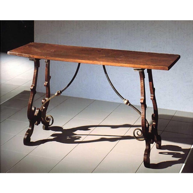 Handcrafted in Italy from solid walnut, this console table features a heavily distressed finish that highlights the...