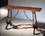 Handcrafted in Italy from solid walnut, this console table features a heavily distressed finish that highlights the...