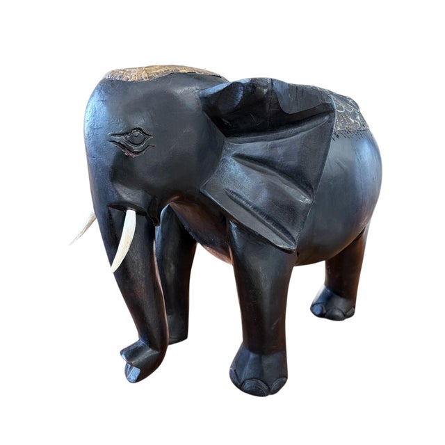 This exceptional hand-carved wooden elephant from Ghana's Asante tradition represents authentic African artisanal mastery....