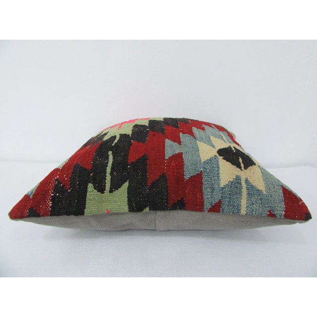 This is a pillow cover made from a vintage kilim rug. The piece was properly washed and ready to use. Pillow inserts not...