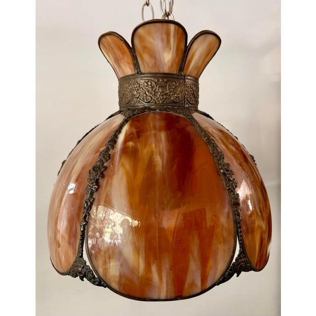 This mid-century amber slag glass pendant lamp shade features a beautifully scalloped floral form with richly marbled...