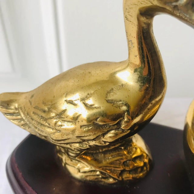 Mid Century brass ducks mounted on wood base.