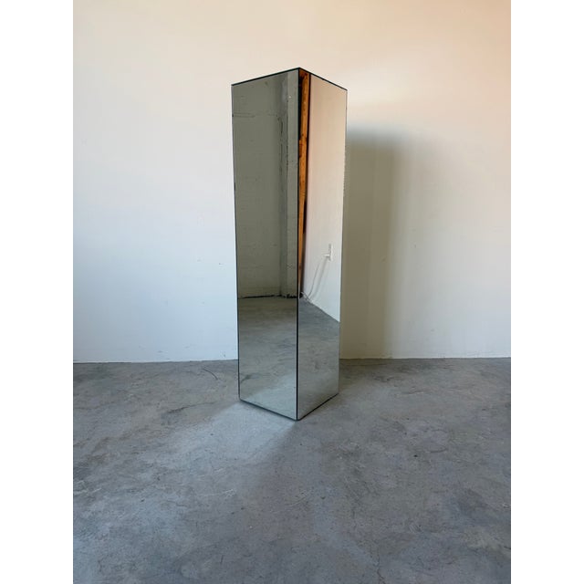 Elegant 1970s vintage pedestal featuring a sleek cube form fully clad in mirrored panels with beveled edges. Its clean,...