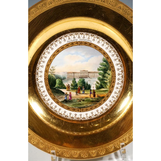Porcelain picture plate with a finely painted polychrome veduta: In the centre, a view of the Viennese summer palace of...