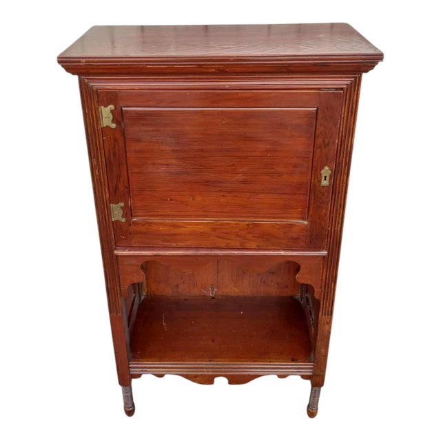 Beautiful 19th century American cabinet with grain-painted rosewood finish. Features a paneled door with brass hardware...