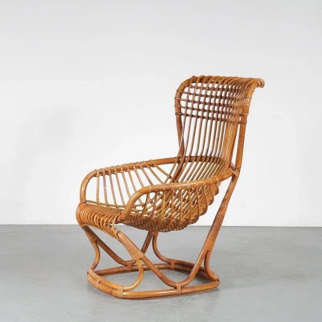 A stunning rattan lounge chair, manufactured in Italy in the 1960s. This eye-catching piece is completely made of the...