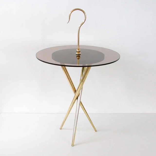 This round tripod occasional table was made in Italy in the 1950s in the manner of Ico Parisi. It has got a brass base, a...