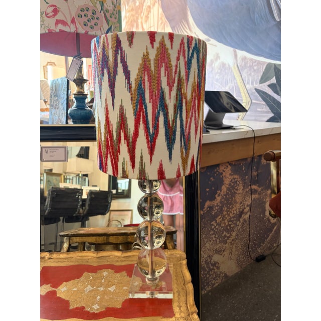 A stylish pair of contemporary table lamps featuring stacked crystal ball bases on polished acrylic plinths, paired with...