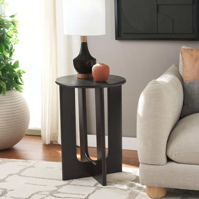 Introducing the ASHANKA End Table, elegantly draped in a sultry black hue. Undeniably captivating, this table is a...