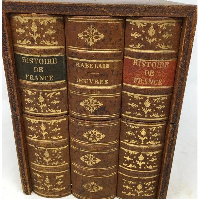 The design of this book box is three books positioned vertically. The box opens diagonally to reveal a partitioned...