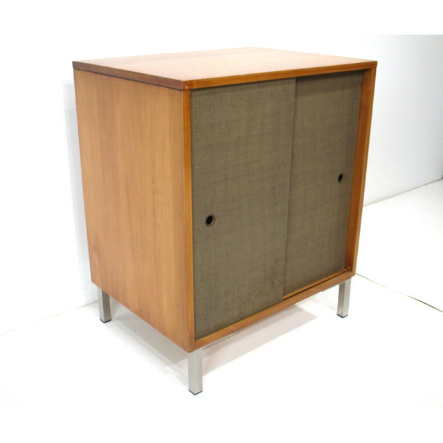 A Mid Century solid maple wood cabinet or bookcase with one nonadjustable shelve and double sliding doors having finger...