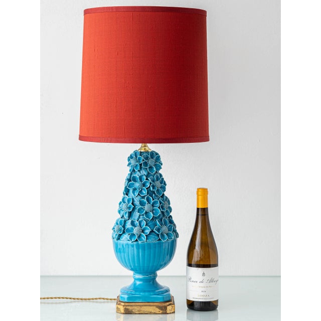 Sculptural mid-century table lamp from manises, spain (1960s). A vivid turquoise glazed bouquet of hand-carved ceramic...
