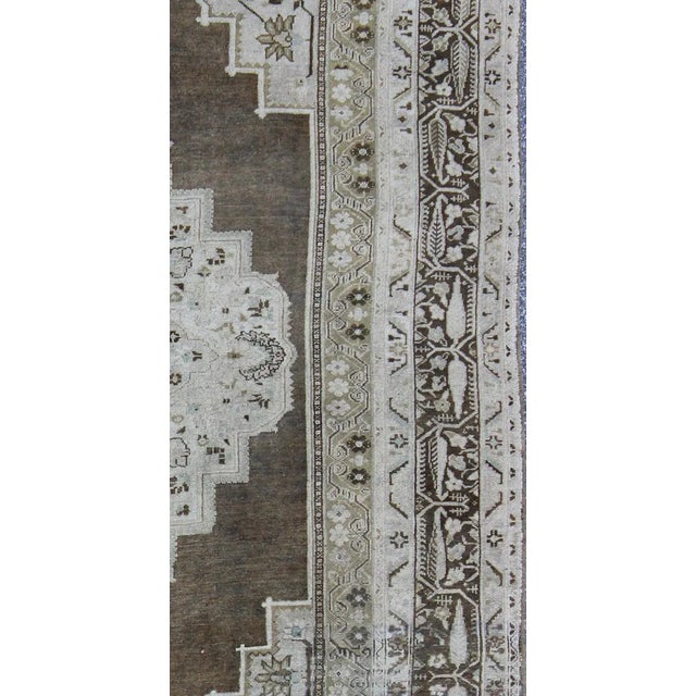 Measures: 7'7 x 12'2 This beautiful Turkish Oushak from mid 20th century Turkey features a Classic medallion Oushak...