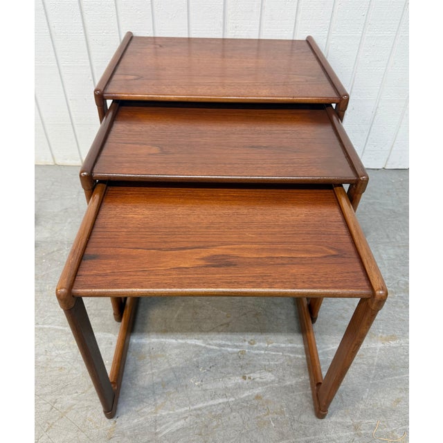 This listing is for a set of three Mid-Century Danish Modern Teak Nesting Tables. Featuring a straight line design,...