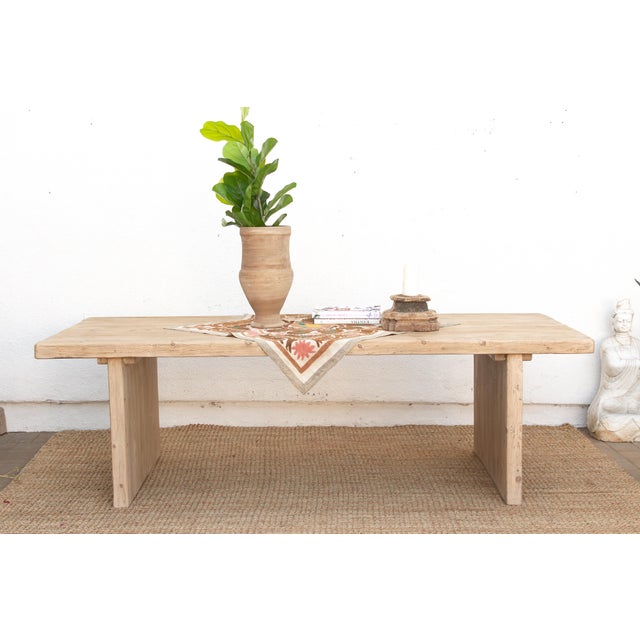 Some tables lean on ornament to make their case; this one relies entirely on proportion. Built from reclaimed wood with a...
