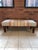 This mid-century circa late 1960s bench is upholstered in a beautifully textured heavy wool-blend woven fabric in a warm...
