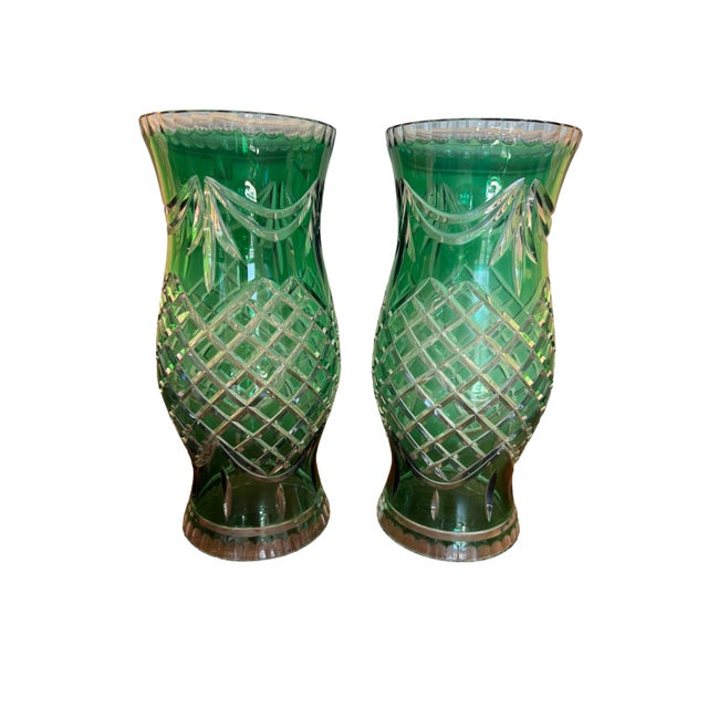 A striking pair of vintage emerald green cut crystal hurricane vases, beautifully faceted with deep diamond patterning and...