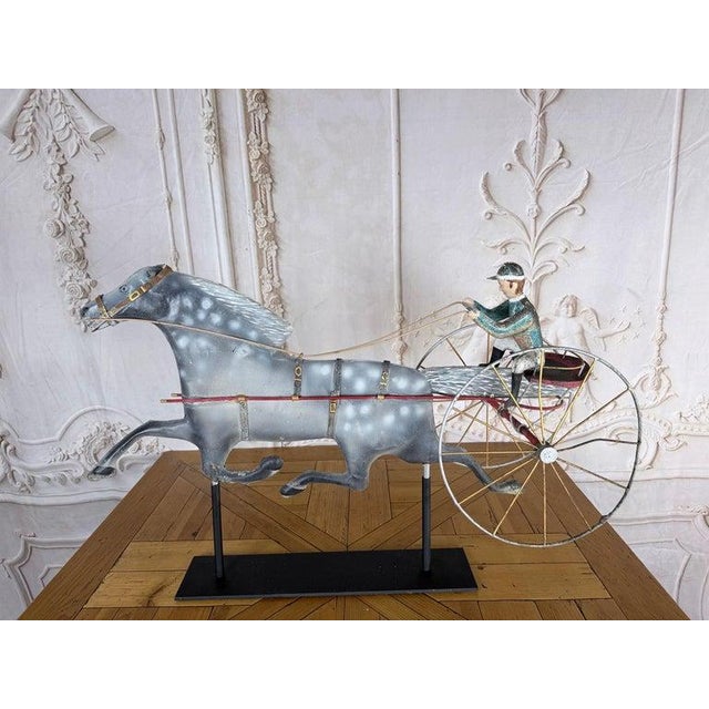 Striking early 20th-century American Folk Art weathervane sculpture depicting a trotting horse pulling a racing sulky with...