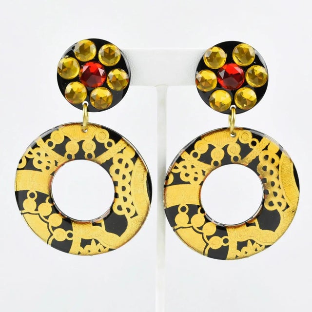 These incredible Italian Lucite or acrylic resin dangling clip-on earrings feature an oversized donut shape with a baroque...
