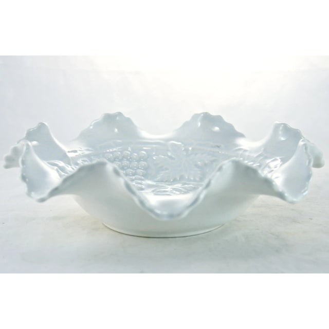Vintage ruffle rim creamy white bowl with by an ice blue over-glaze highlighting a raised majolica style grape leaf...