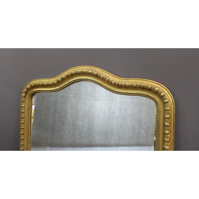 Large original gilt stucco mirror, top of the mirror in a gendarme's hat shape, Napoleon III period, overall in good...