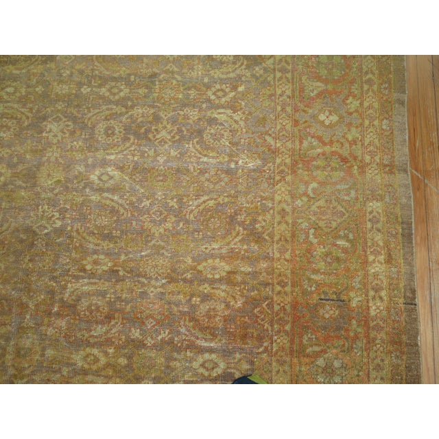 A large oversize antique square Mahal rug in brown camel and burnt orange. This piece is one of the more difficult rugs we...