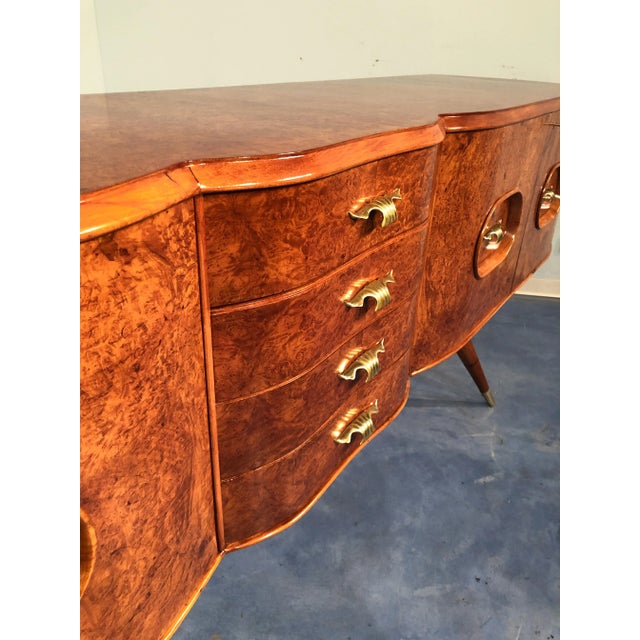 Beautiful Italian mid-century sideboard made of birch wood that gives the sideboard a warm honey color. The sideboard has...
