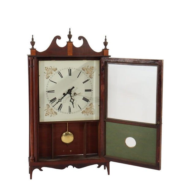 A vintage Seth Thomas pillar and scroll mantle clock, produced in the mid-20th century. This handsome timepiece is crafted...