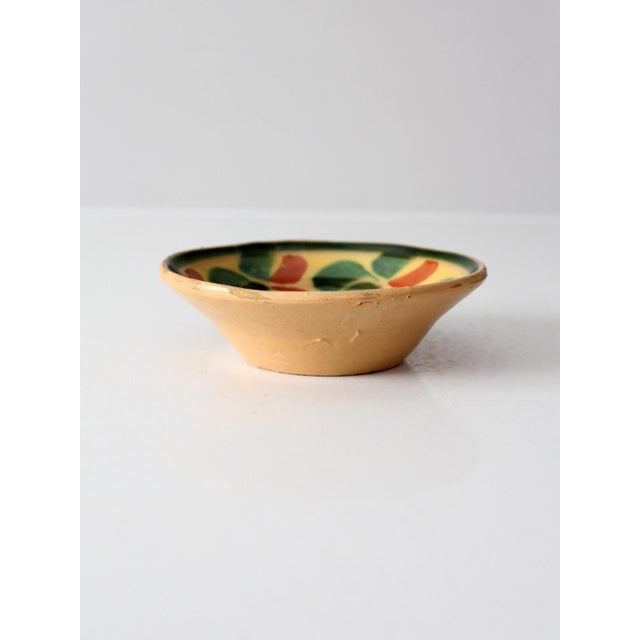 This vintage mid-century Mexican pottery bowl features a shallow, organically shaped form decorated with hand-painted...