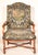 French Regence walnut armchair with tapestry upholstery, 18th century. With a tapestry upholstered back with brass nail...