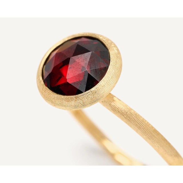 This gorgeous ring by Italian designer Marco Bicego and from their Jaipur Collection, contains a round rose cut garnet...