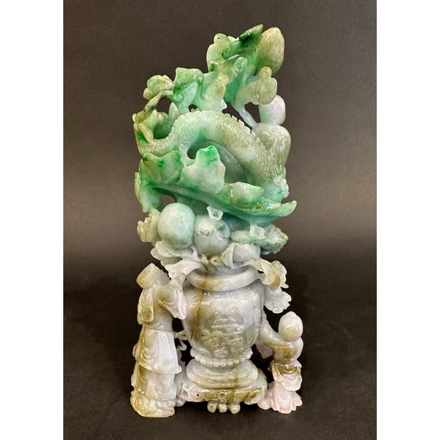 A dragon in flight posed amongst Chinese flora & three wise men who bear witness to his presence, scrolls and books in...