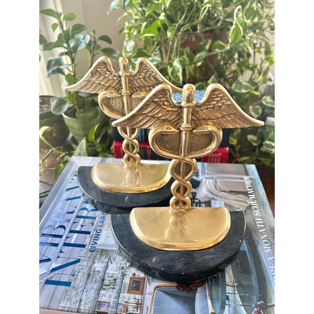 Perfect for the doctors office or medical student, this pair of brass and marble bookends feature the caduceus medical...