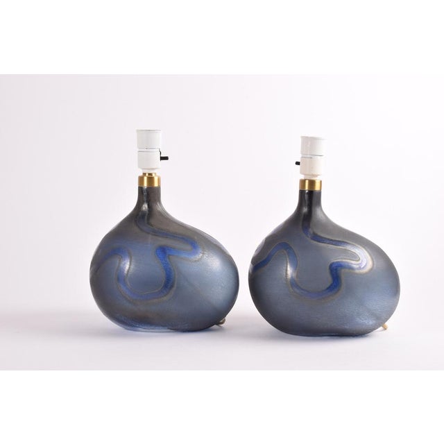 Pair of Danish midcentury sculptural hand blown glass lamps designed by Michael Bang and made by Holmegaard. They are from...