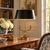 A classic bouillotte lamp rendered in warm brass, distinguished by its sculptural double dolphin motif and clean, tailored...